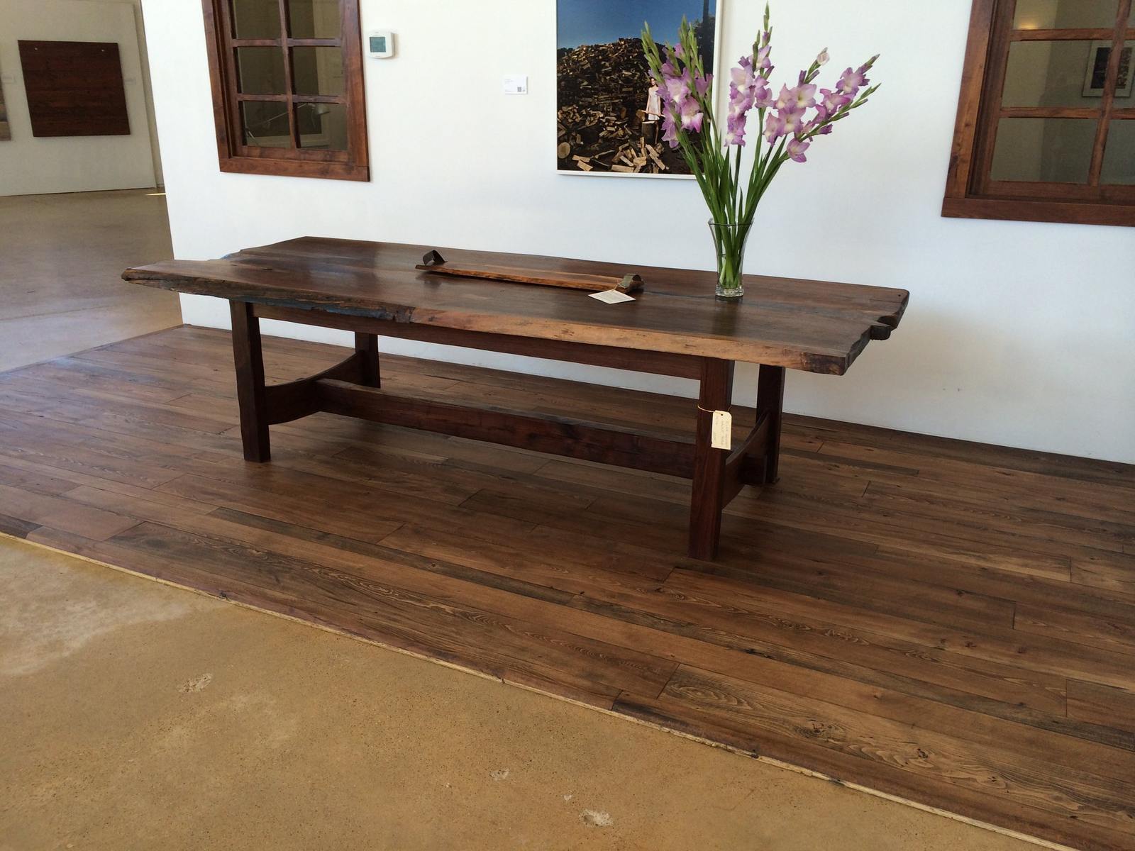Full view of the black-walnut live-edge table in a finished room